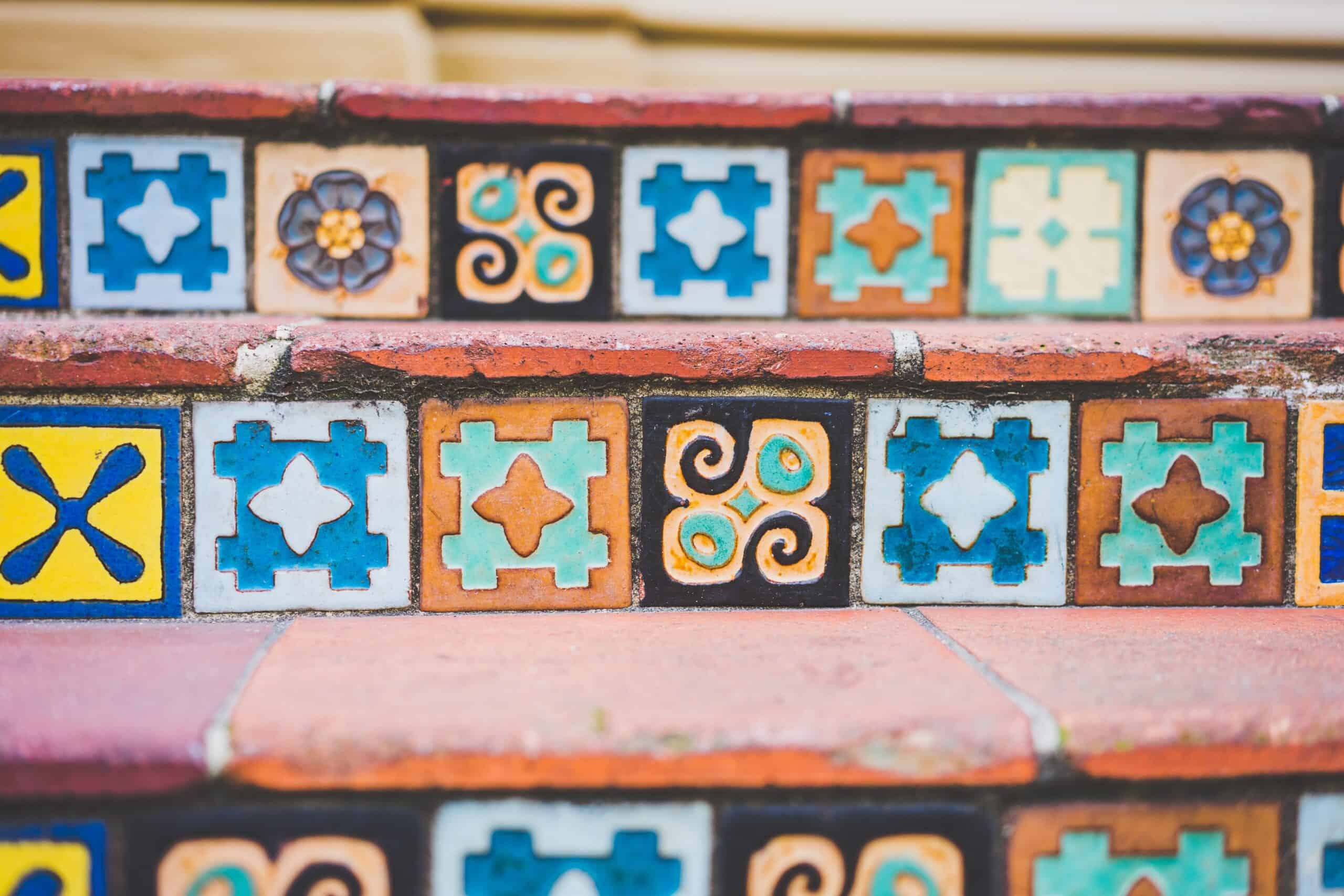 small, colourful, patterned tiles set into the facing-edge of outdoor stairs